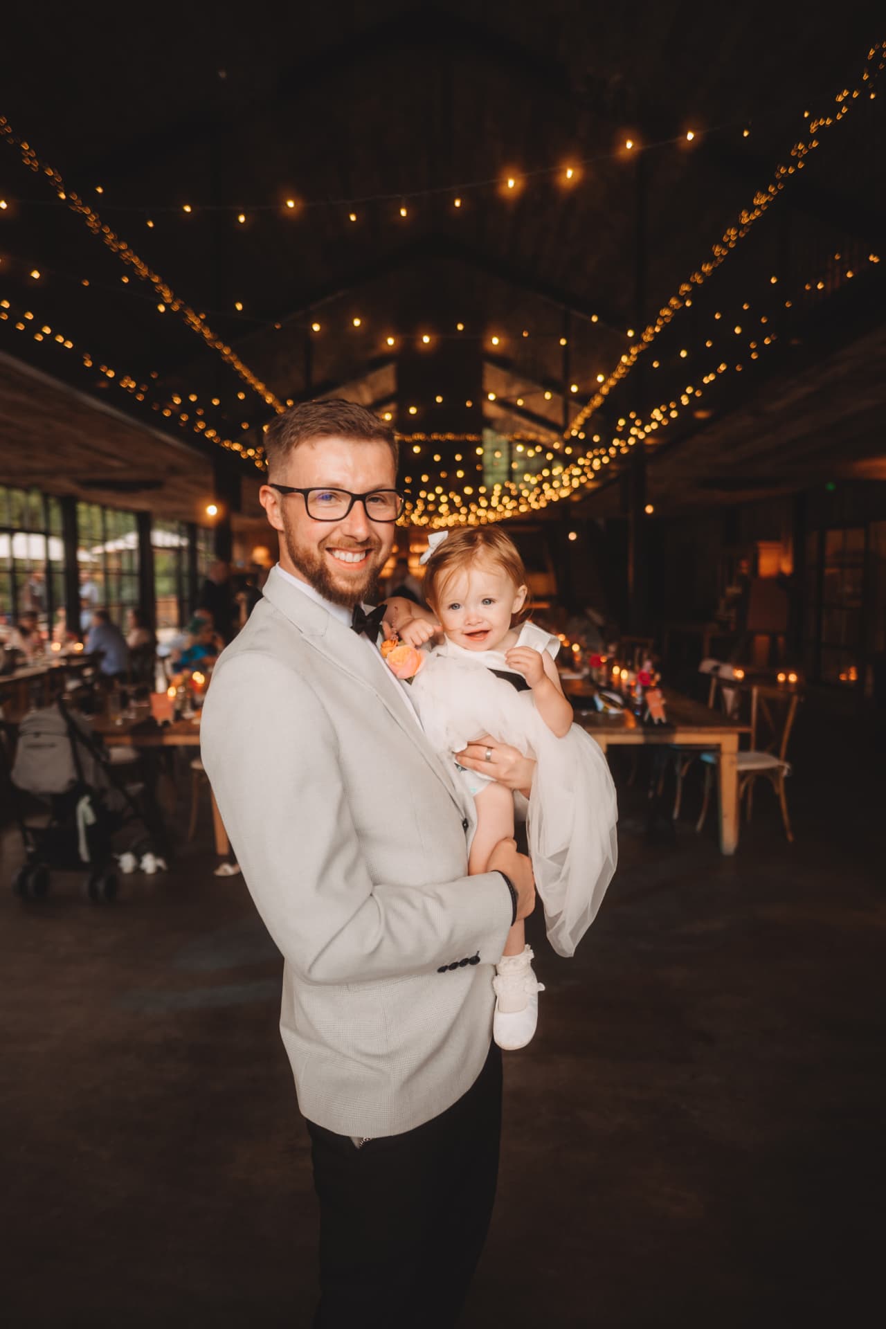 Ash Davidson smiling with a young child
